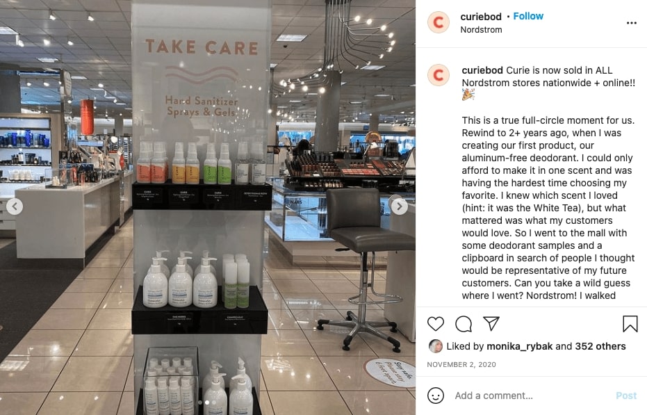 A shelf inside of Nordstrom that says _take care. Hand sanitizer sprays and gels._ On the top shelf if a line of Curie products